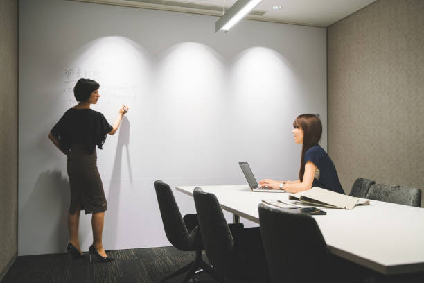 istock Businesswomen discussing project in modern office 696190318