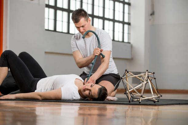 альтернативная терапия с давлением точки stick, чтобы сбалансировать тело - crouching exercising anatomy human muscle стоковые фото и изображения