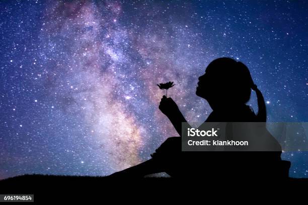 Silhouette Of Little Girl Holding A Flower Stock Photo - Download Image Now - Child, Outer Space, Star - Space