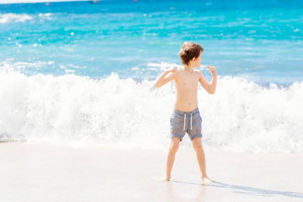 istock Little boy playing at the beach. Happy summer vacations. 696195062