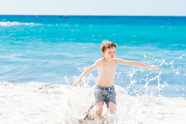 istock Little boy playing at the beach. Happy summer vacations. 696195108