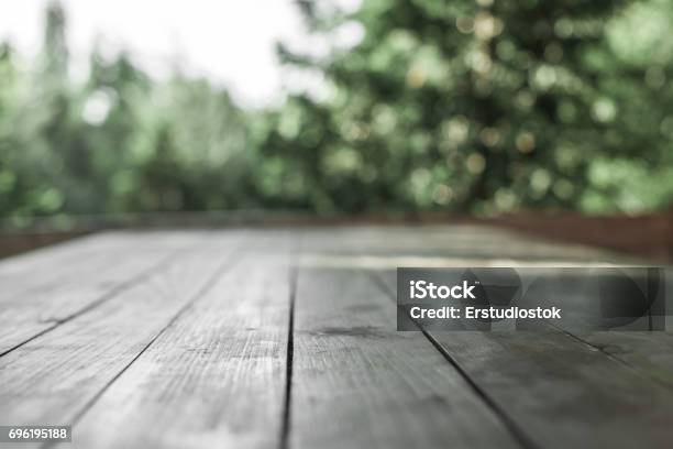 Wooden Board In Front Of Blurred Nature Background Stock Photo - Download Image Now