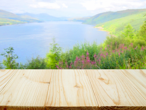 Wooden table and view of beautiful lake and mountain