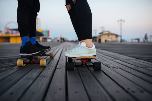 istock Couple riding longboards 696198032