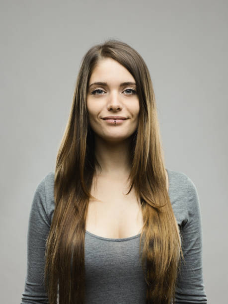 istock Smiling young woman studio portrait 696198350