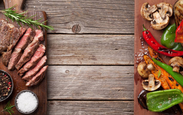 istock Beef steak and grilled vegetables on cutting board 696202234