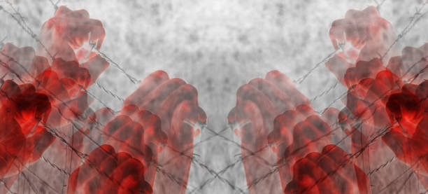 istock Artistic blood tortured hand grasping desperately barbed wire 696205222