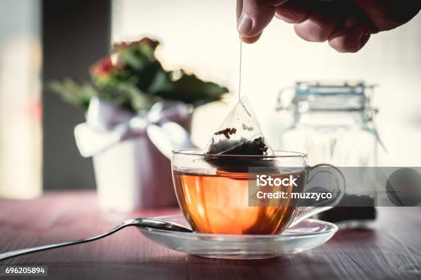 Someone Preparing Tea Stock Photo - Download Image Now - Teabag, Black Tea, Cup