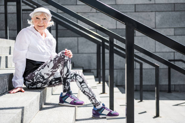 istock Joyful aged lady relaxing after climbing upstairs 696206628