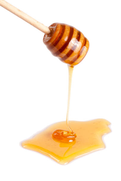 istock Honey stick with flowing honey isolated on white background 696208950