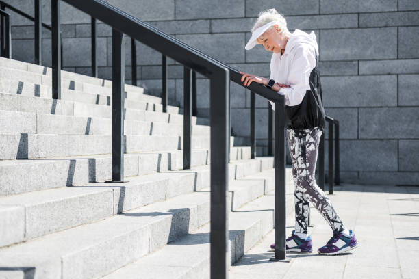 istock Exhausted old woman having time to rest before raising upstairs 696209032