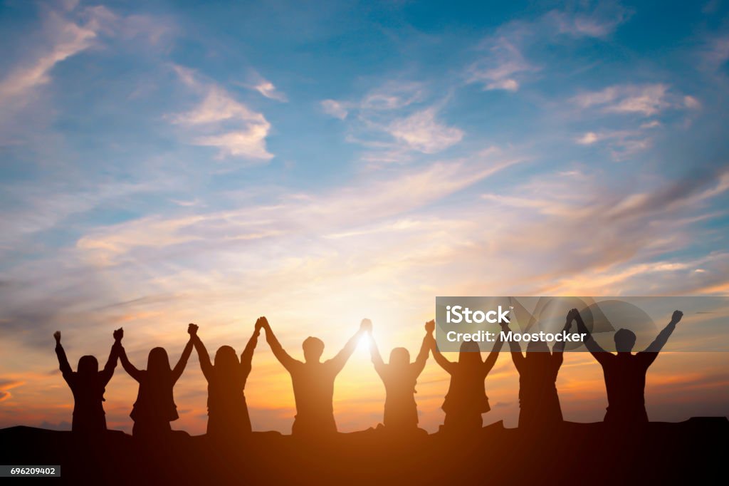 Silhouette der glücklich Business Team macht hohe Hände im Sonnenuntergang Himmelshintergrund für Teamarbeit Geschäftskonzept - Lizenzfrei Zusammenarbeit Stock-Foto