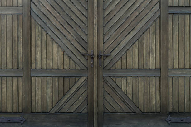 istock wooden door with iron handles 696217566