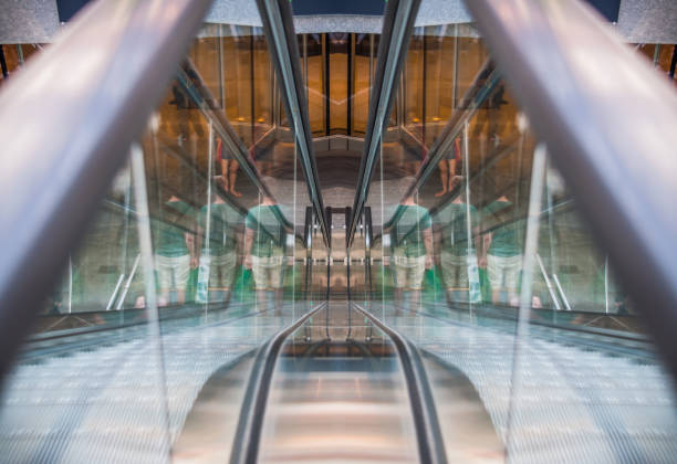 istock Reflection of a man on the escalators 696217786