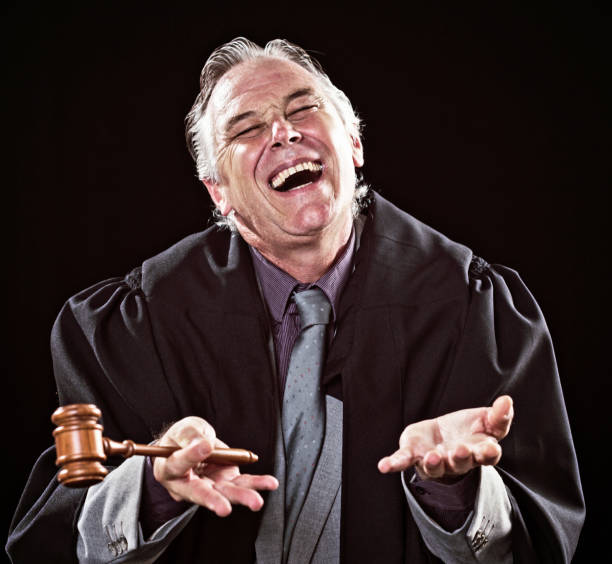 istock Judge laughing helplessly in courtroom 696220440