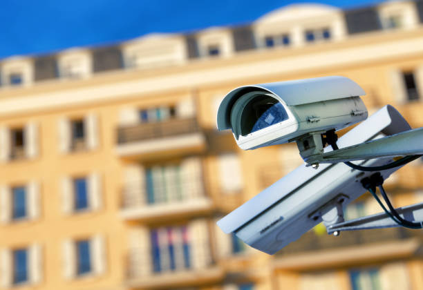 istock security CCTV camera or surveillance system with modern luxury residence on blurry background 696224964