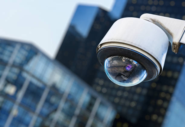 istock cctv security camera in a city with blury business building on background 696224968