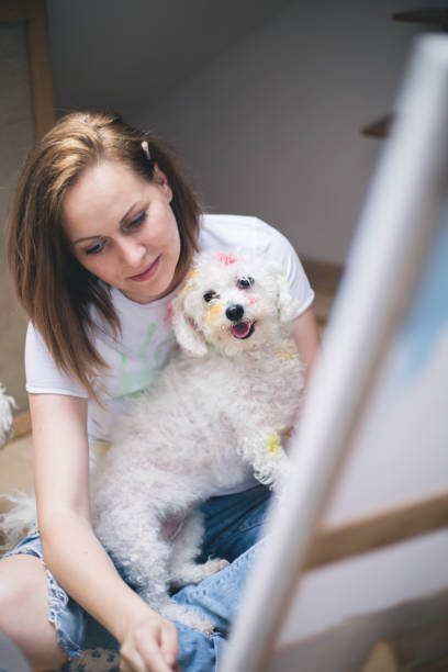 istock Getting creative.woman painting with his dog in his studio 696227554