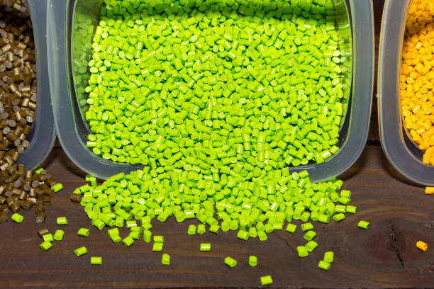 istock Plastic pellets are poured from a measuring container on laboratory table 696231094