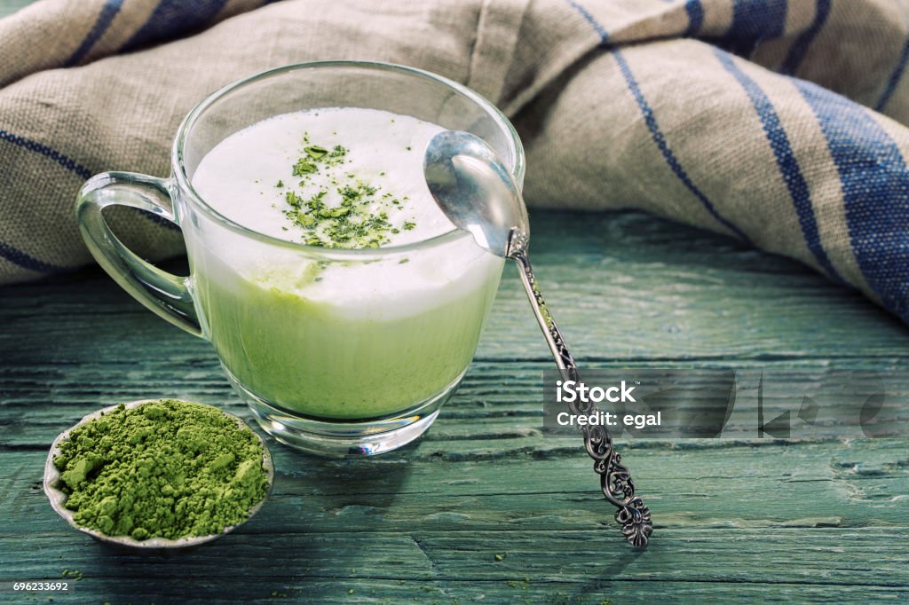 Matcha green tea latte Matcha green tea latte on a wooden background Matcha Tea Stock Photo