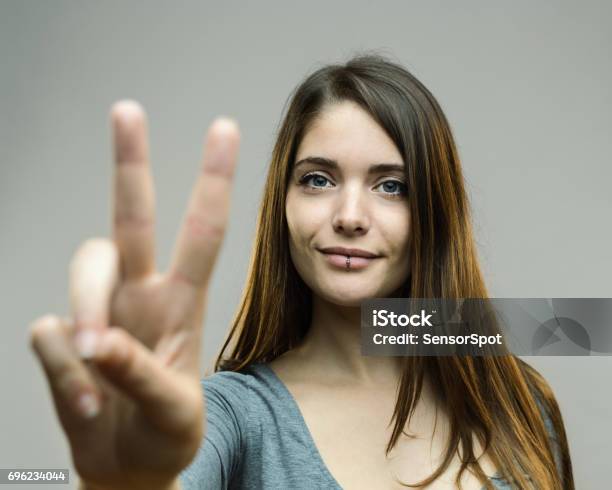Real Woman Showing Victory Sign Stock Photo - Download Image Now - Peace Sign - Gesture, Symbols Of Peace, Finger