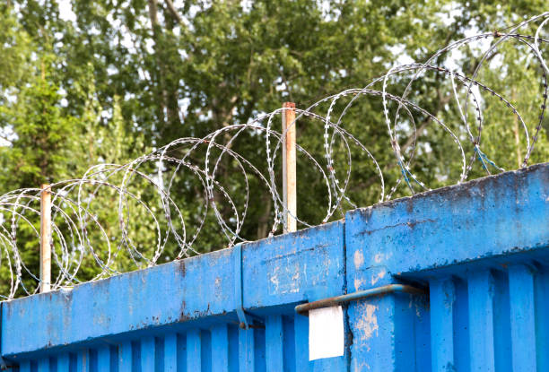 istock barbed wire on the wall in Russian jail 696235202