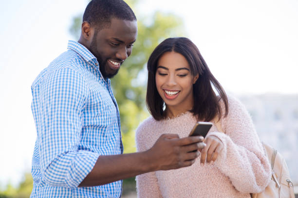 istock Energetic happy couple choosing the restaurant online 696243374