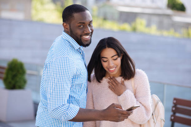 istock Attractive easygoing guy showing his friend some photos 696243620