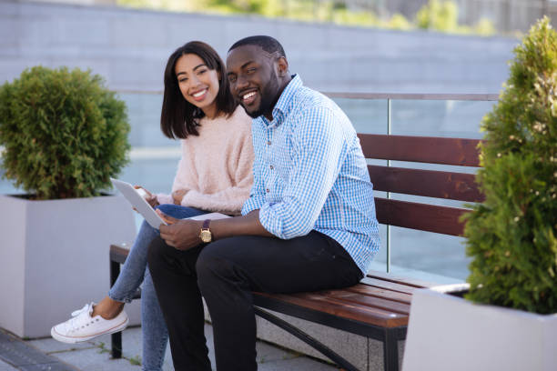 istock Bright modern couple enjoying online shopping 696243850