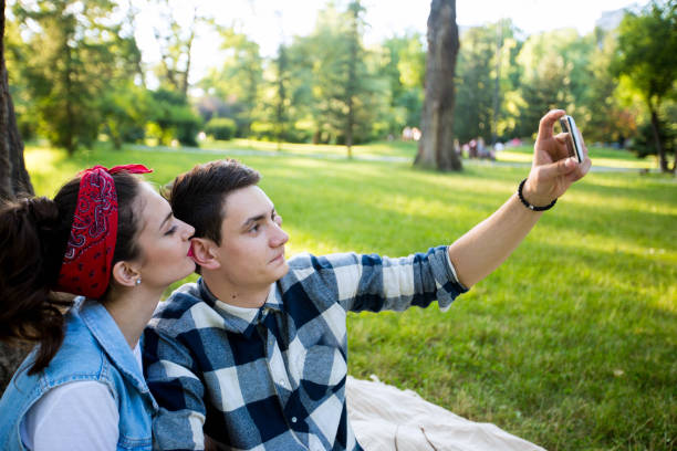 istock Young couple taking a selfie on a picnic 696247716