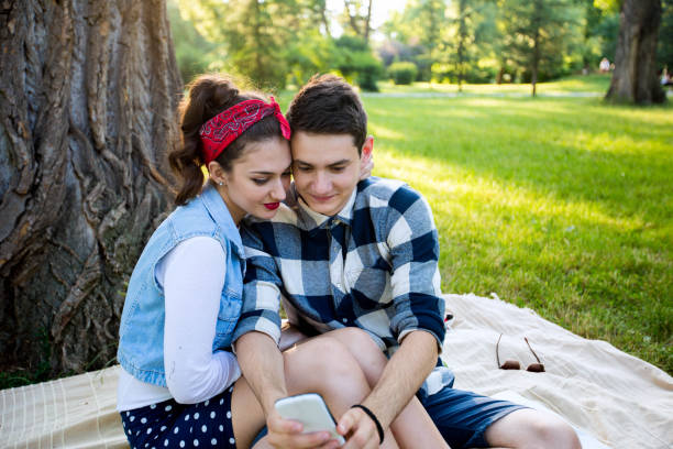 istock Beautiful couple taking a selfie on a picnic 696247744