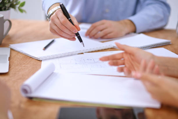 istock Hands of business people meeting around table 696247806