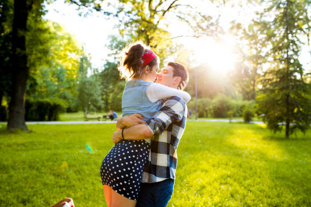istock Sweet boy spin, hug and kiss his girlfriend 696248018
