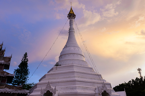 The white Buddhist  pagoda with the twilight scene at the north of Thailand.Most famous landmark for Meahongson province.
