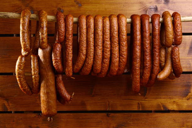 istock Sausage hanged on wooden background 696251264