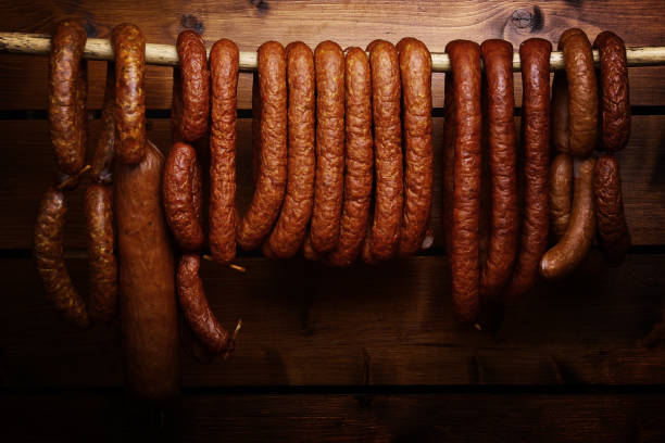 istock Sausage hanged on wooden background 696251296