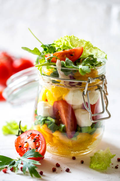 istock Hand made vegetable salad with Mozarella, tomatoes, peppers, herbs and onions 696251534