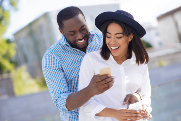 istock Charming enthusiastic man sharing something interesting with his girlfriend 696254454