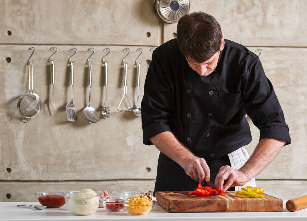istock Restuarant hotel private chef cutting red pepper on board 696254552