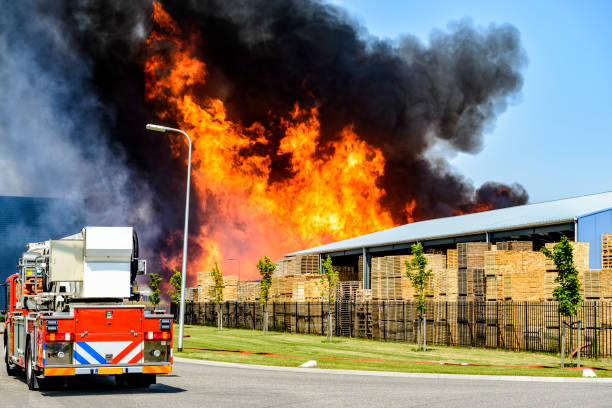 istock Fire truck at a large fire in an industrial area 696254784