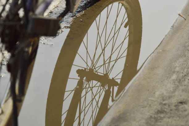 Orange reflector on the bicycle wheel. Safety device. Bike wheel reflector.