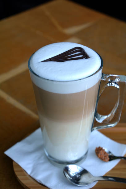 istock Latte Macchiato On Glass Cup On A Wooden Table 696257442