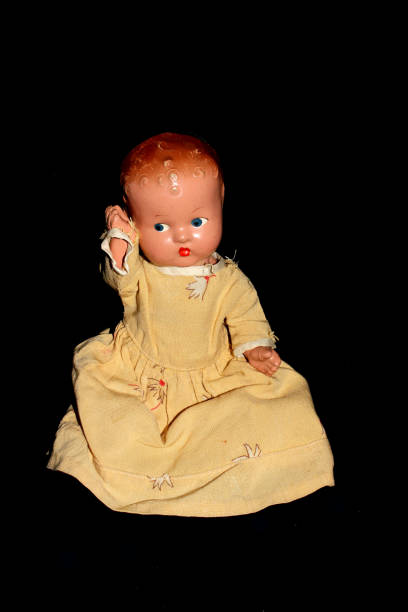 istock Antique Toy Dolly On Black Background 696258644