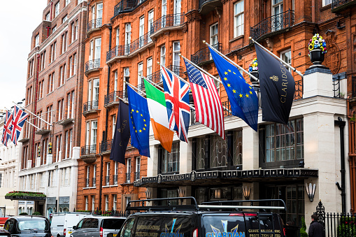 London, UK - 18 May, 2017: exterior view of the Victorian architecture of the luxury hotel Claridge's in Mayfair, central London, UK. The hotel is world famous for being one of the most luxurious and exclusive hotels in London and globally. Outside the hotel, busy London traffic lines the roads. Horizontal colour image with copy space.