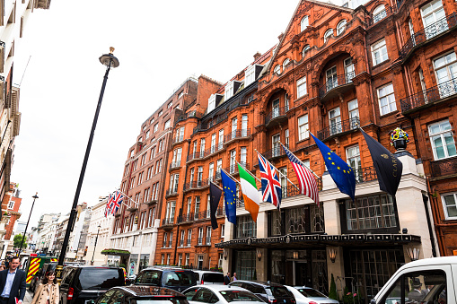 London, UK - 18 May, 2017: exterior view of the Victorian architecture of the luxury hotel Claridge's in Mayfair, central London, UK. The hotel is world famous for being one of the most luxurious and exclusive hotels in London and globally. Outside the hotel, busy London traffic lines the roads. Horizontal colour image with copy space.
