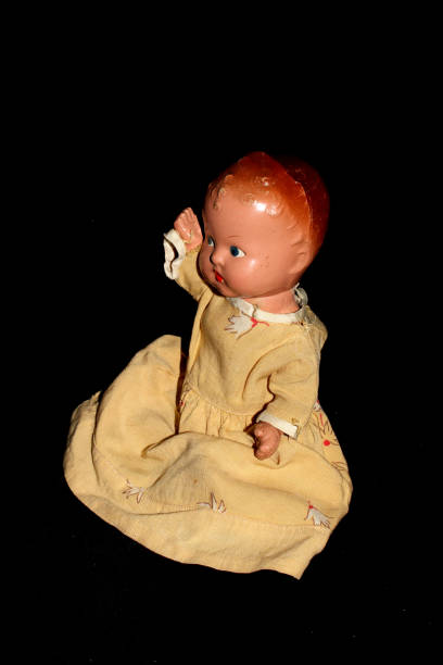 istock Antique Toy Dolly On Black Background 696258794