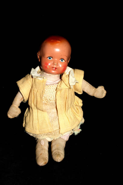 istock Antique Toy Dolly On Black Background 696259204