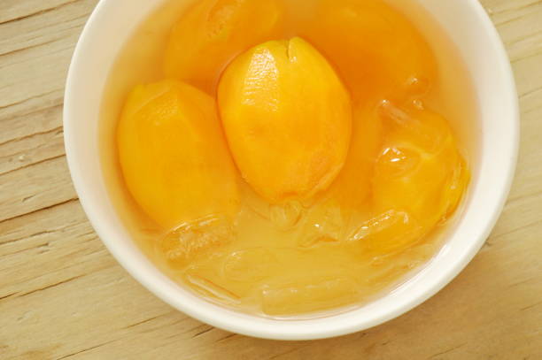 istock Marian plum tropical fruit in syrup with ice on cup 696261468