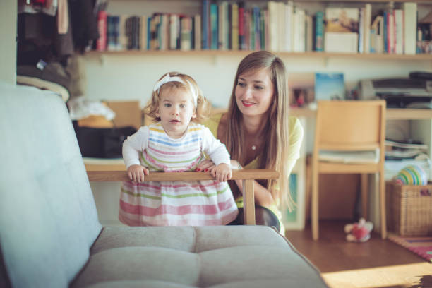 istock Mother and her little daughter at home 696274716