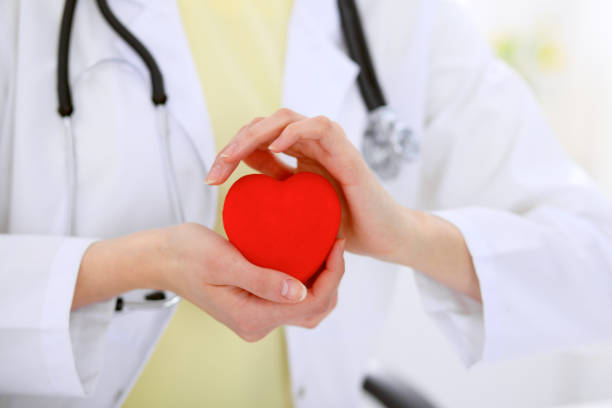 istock Female doctor with stethoscope holding heart. 696274842